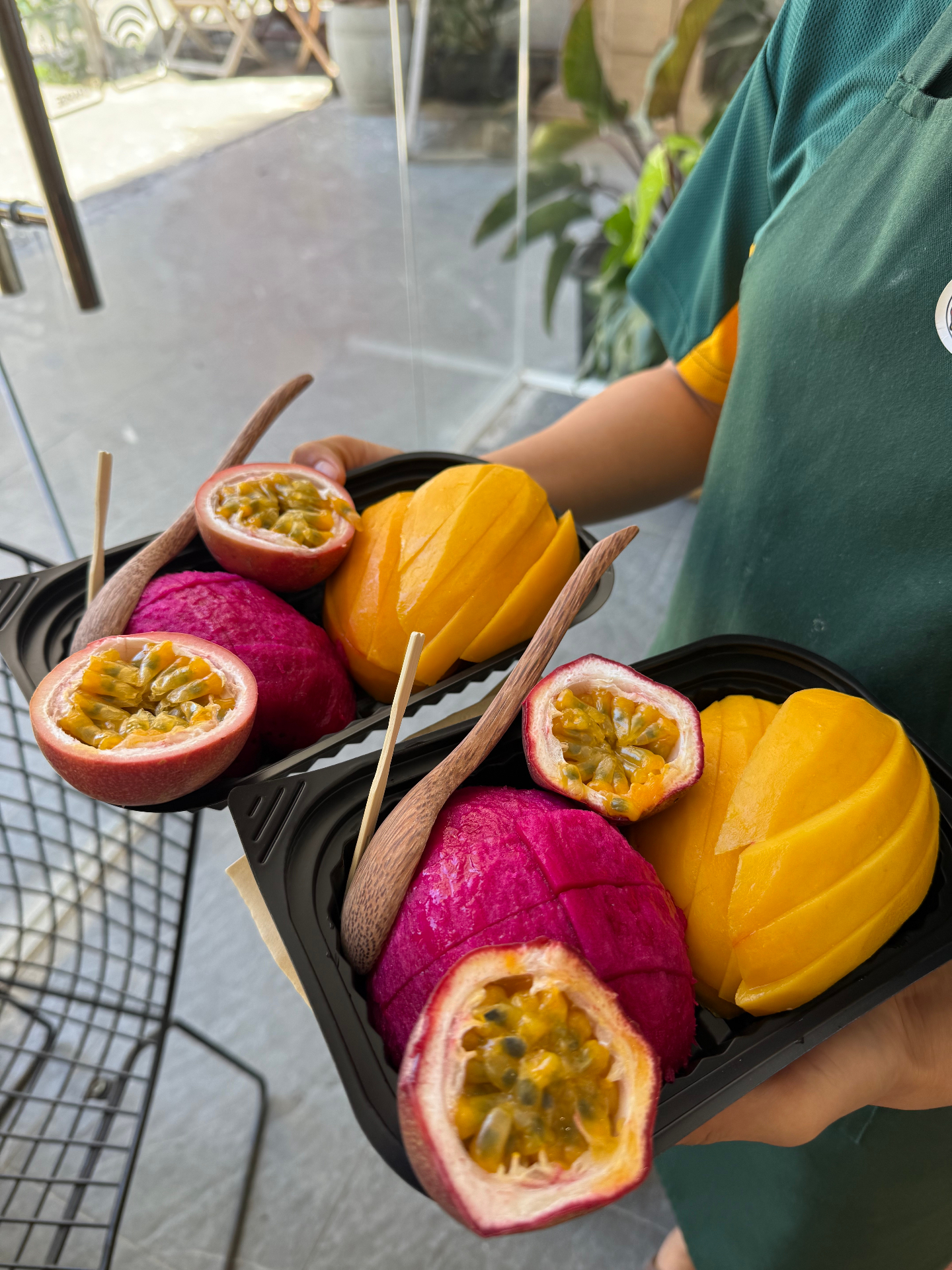Fresh cut mango, passion fruit and dragon fruit served in trays at Tropi Farm